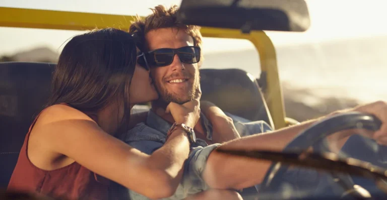 Couple with sunglasses enjoying a romantic moment.